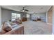 Large main bedroom with carpet, ceiling fans, sitting area with couch, windows, and private ensuite bathroom at 4481 Grey Spencer Dr, Las Vegas, NV 89141