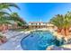 Stunning backyard oasis showcasing a sparkling pool, rock accents, and lush tropical landscaping at 4481 Grey Spencer Dr, Las Vegas, NV 89141