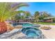 Luxurious pool and spa combo with rock waterfall feature, set amidst a beautifully landscaped backyard at 4481 Grey Spencer Dr, Las Vegas, NV 89141
