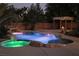 Backyard pool with waterfall feature, jacuzzi, and outdoor fireplace at 4481 Grey Spencer Dr, Las Vegas, NV 89141