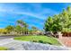 Neighborhood street view featuring lush landscaping, mature trees, and elegant community signage at 4481 Grey Spencer Dr, Las Vegas, NV 89141