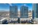 Contemporary high-rise buildings with blue glass facade, parking garage, and lush landscaping at 4575 Dean Martin Dr # 1201, Las Vegas, NV 89103