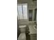 Bathroom featuring a vanity and window with blinds and a light fixture above at 503 Crony Ave, Henderson, NV 89011