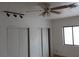Bedroom featuring modern ceiling fan, a large window, and closet storage space at 503 Crony Ave, Henderson, NV 89011