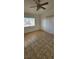 Bedroom with tile flooring, ceiling fan, window with blinds, and sliding glass door at 503 Crony Ave, Henderson, NV 89011
