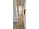 Hallway view featuring tile flooring, white walls, and storage cabinets at 503 Crony Ave, Henderson, NV 89011