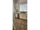 Bright kitchen features stainless steel appliances, double sink, and white cabinetry at 503 Crony Ave, Henderson, NV 89011