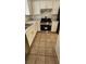 A view of the kitchen with stainless steel appliances and sleek white cabinets at 503 Crony Ave, Henderson, NV 89011