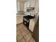 Kitchen featuring stainless steel oven, range hood, and white cabinets at 503 Crony Ave, Henderson, NV 89011