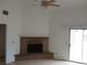 Bright living room featuring a brick fireplace, tiled floors, and sliding glass door to the backyard at 503 Crony Ave, Henderson, NV 89011