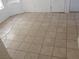 Bright room with neutral-toned tile flooring, a window, and a door at 503 Crony Ave, Henderson, NV 89011
