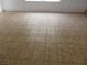 Room filled with neutral-toned tile flooring and bright natural light from the windows at 503 Crony Ave, Henderson, NV 89011