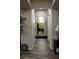 Hallway with wood-look flooring and doors leading to a laundry room and other spaces at 5096 Maverick, Las Vegas, NV 89130