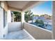 Balcony overlooking a parking area with garage doors and mature trees at 5250 S Rainbow Blvd # 2033, Las Vegas, NV 89118
