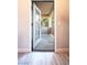 View from an open doorway to a balcony overlooking trees, the ground is wood-look flooring at 5250 S Rainbow Blvd # 2033, Las Vegas, NV 89118