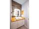 Bathroom featuring a modern vanity, wood countertop, and illuminated mirror with accent wall at 5250 S Rainbow Blvd # 2033, Las Vegas, NV 89118