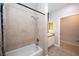 Bathtub and sink with modern fixtures and tiled shower in a bright bathroom at 5250 S Rainbow Blvd # 2033, Las Vegas, NV 89118