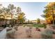 Community green space featuring mature trees, walking paths, landscaping, and putting green at 5250 S Rainbow Blvd # 2033, Las Vegas, NV 89118