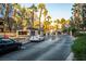 Automated entrance to a gated community with palm trees and manicured shrubbery on a sunny day at 5250 S Rainbow Blvd # 2033, Las Vegas, NV 89118