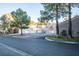 Attractive exterior with multiple garages, nearby parking, and mature landscaping at 5250 S Rainbow Blvd # 2033, Las Vegas, NV 89118
