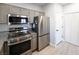 Kitchen with stainless steel appliances, granite countertops, and convenient pantry storage at 5250 S Rainbow Blvd # 2033, Las Vegas, NV 89118