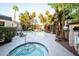 Beautiful community pool and hot tub surrounded by mature palm trees and lush landscaping at 5250 S Rainbow Blvd # 2033, Las Vegas, NV 89118