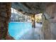 Resort-style pool features a simulated rock cave with lush landscaping and lounge chairs at 5250 S Rainbow Blvd # 2033, Las Vegas, NV 89118