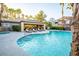 Beautiful community pool features lounge chairs, tables, and a shaded eating area on a sunny day at 5250 S Rainbow Blvd # 2033, Las Vegas, NV 89118