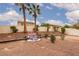 Spacious backyard with desert landscape, a decorative water feature, a rock bed and a view of palm trees at 5609 Hannah Gordon Ct, North Las Vegas, NV 89081