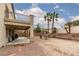 Backyard with patio, desert landscaping and mature palm trees at 5609 Hannah Gordon Ct, North Las Vegas, NV 89081