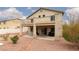 Backyard with a covered patio, desert landscaping and an upper balcony at 5609 Hannah Gordon Ct, North Las Vegas, NV 89081