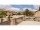 Balcony view overlooking neighboring houses and community pool with palm trees at 5609 Hannah Gordon Ct, North Las Vegas, NV 89081