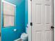 Powder room with bright blue walls, white toilet, and a window for natural light at 5609 Hannah Gordon Ct, North Las Vegas, NV 89081