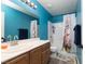 Bright bathroom with a modern vanity, wooden cabinets, and a shower/tub combo with a fox-themed shower curtain at 5609 Hannah Gordon Ct, North Las Vegas, NV 89081