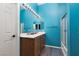Well-lit bathroom with a dual sink vanity, wooden cabinets, large mirrors, and a shower/tub combo at 5609 Hannah Gordon Ct, North Las Vegas, NV 89081