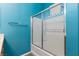 Contemporary bathroom featuring an enclosed shower/tub combo and blue walls at 5609 Hannah Gordon Ct, North Las Vegas, NV 89081