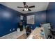 Bedroom featuring a ceiling fan, carpeted floors, and a comfortable workspace with an office setup at 5609 Hannah Gordon Ct, North Las Vegas, NV 89081