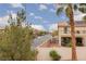 Street view of house with small shed, balcony, mature trees, and well-maintained landscape at 5609 Hannah Gordon Ct, North Las Vegas, NV 89081
