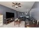 Spacious living room featuring a large TV, comfortable seating, and ceiling fan at 5609 Hannah Gordon Ct, North Las Vegas, NV 89081