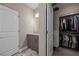 Bathroom with a door to walk-in closet, modern sink, and patterned rug at 571 Marilyn Pkwy # 4, Mesquite, NV 89027