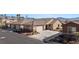 Attractive exterior showcasing a well-maintained home with a three-car garage and desert landscaping at 571 Marilyn Pkwy # 4, Mesquite, NV 89027