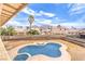 Backyard with kidney shaped pool and views of surrounding homes and distant mountains at 5751 E Owens Ave, Las Vegas, NV 89110