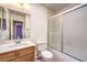 A pristine bathroom featuring a shower with sliding doors, a white toilet, and a vanity at 5751 E Owens Ave, Las Vegas, NV 89110