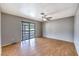 A bedroom with wood laminate flooring, a ceiling fan and a sliding glass door to the outside at 5751 E Owens Ave, Las Vegas, NV 89110