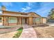 Inviting two-story house featuring a walkway to the front door and an attached garage at 5751 E Owens Ave, Las Vegas, NV 89110