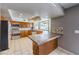 Well-lit kitchen boasts stainless steel appliances, tile countertops, and a breakfast bar area at 5751 E Owens Ave, Las Vegas, NV 89110