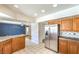 Large kitchen with stainless steel refrigerator, tile countertops, and open layout perfect for entertaining at 5751 E Owens Ave, Las Vegas, NV 89110