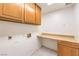 A laundry room that includes overhead cabinets, counter space and a tile floor at 5751 E Owens Ave, Las Vegas, NV 89110