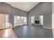 The living room features high ceilings, large windows, a stone fireplace, and a front door view at 5751 E Owens Ave, Las Vegas, NV 89110