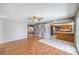 Open-concept living area with modern barn doors leading to kitchen with breakfast bar and stainless steel appliances at 5751 E Owens Ave, Las Vegas, NV 89110